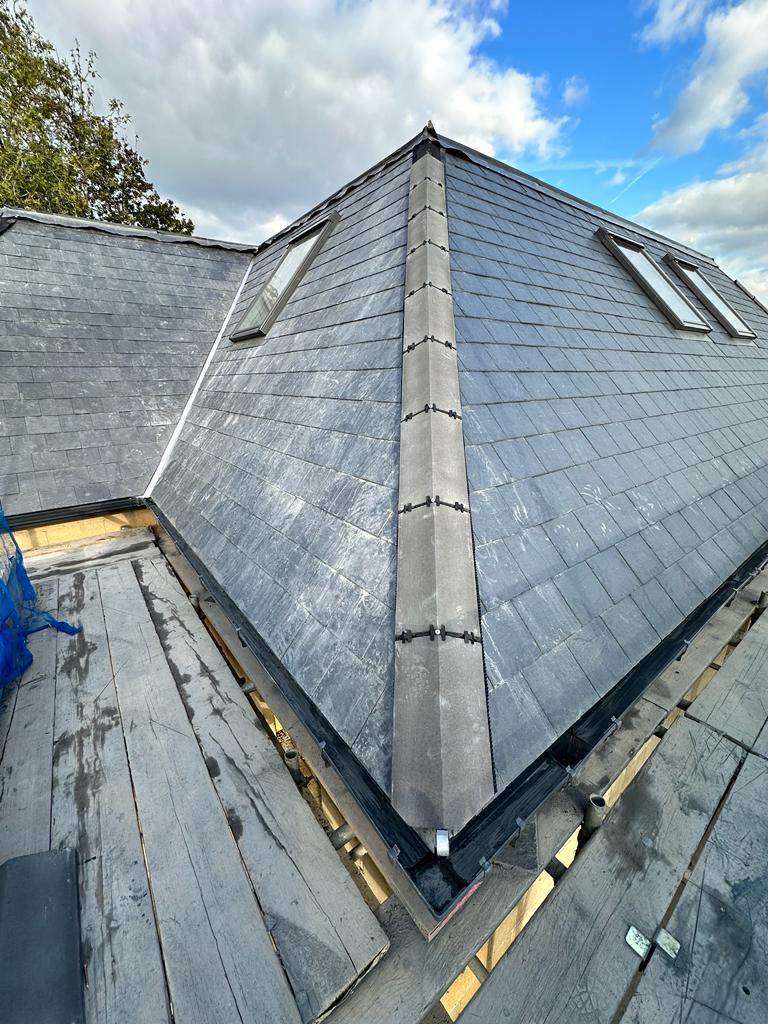 Professional slate roof installation with skylight