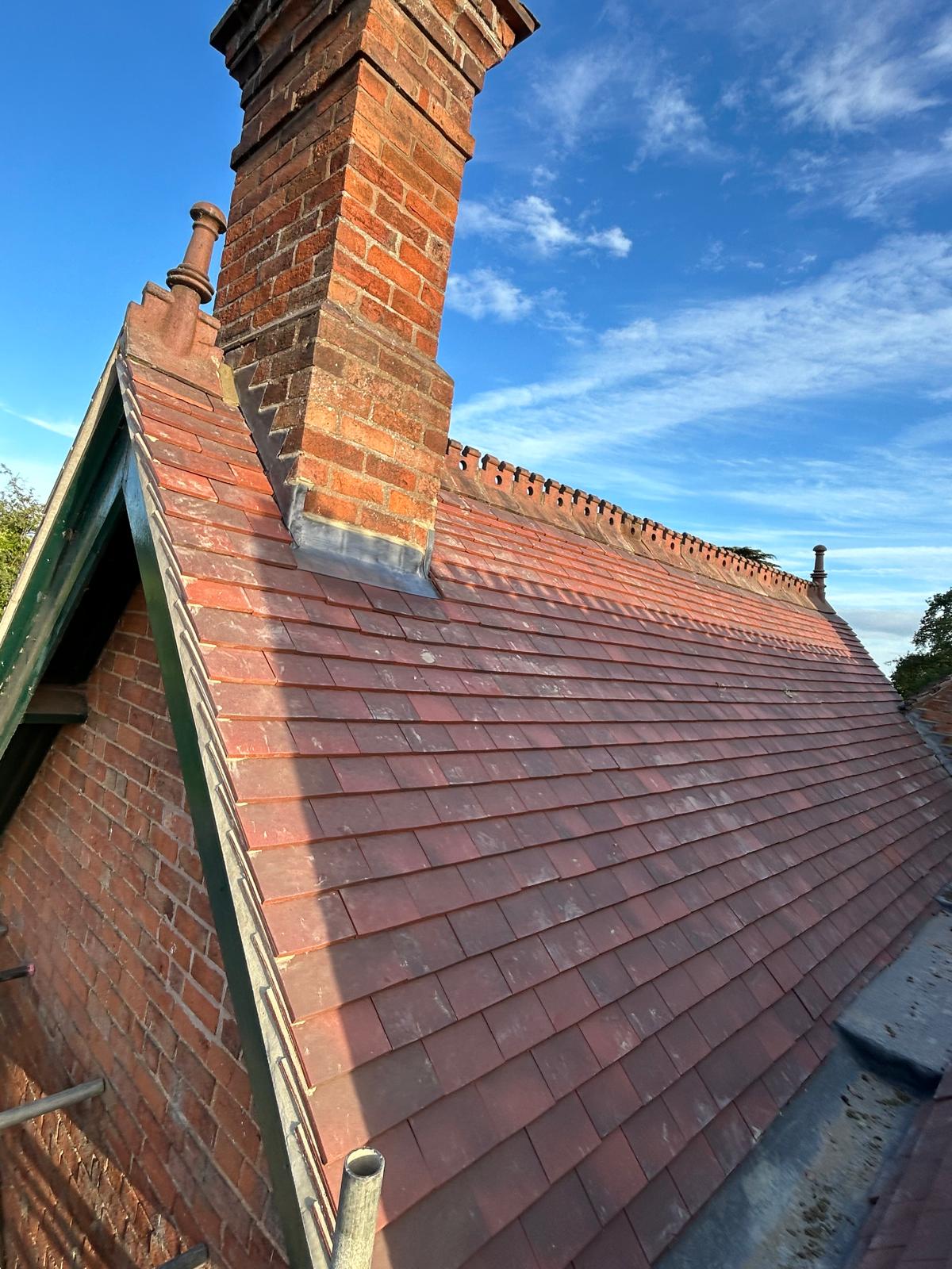 Slate roof installation with chimney