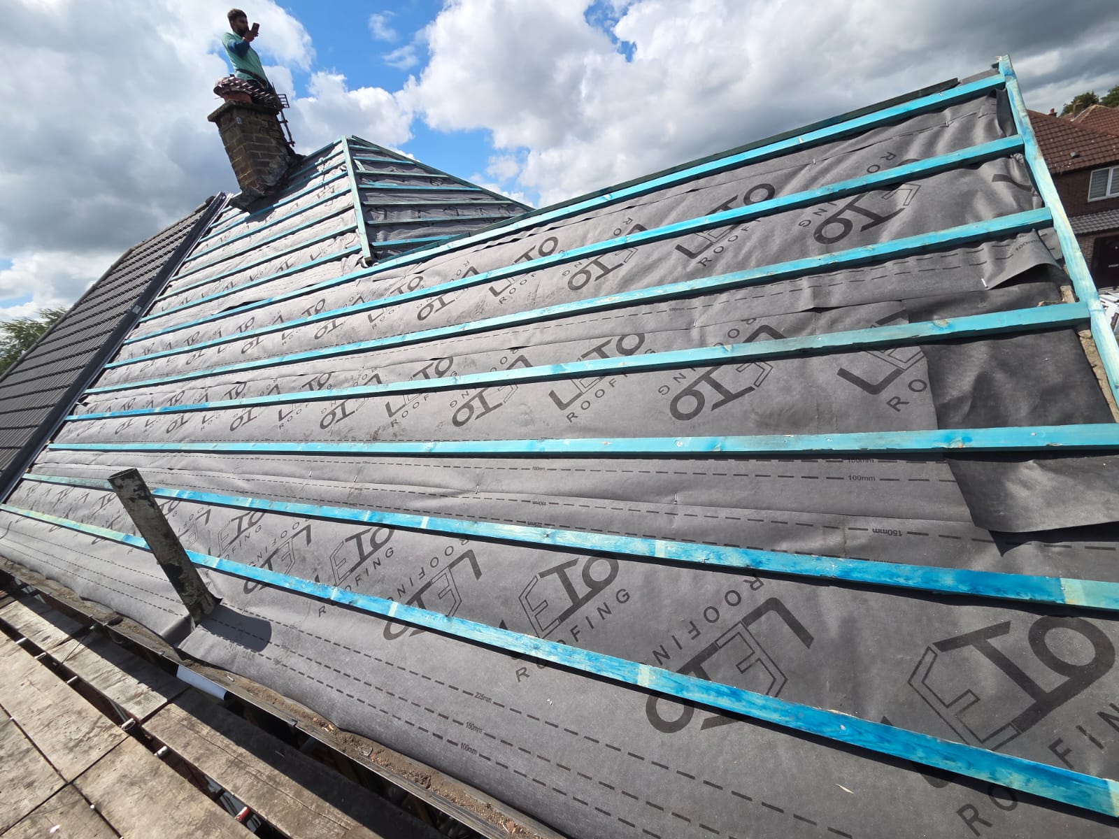 Completed slate roof with chimney
