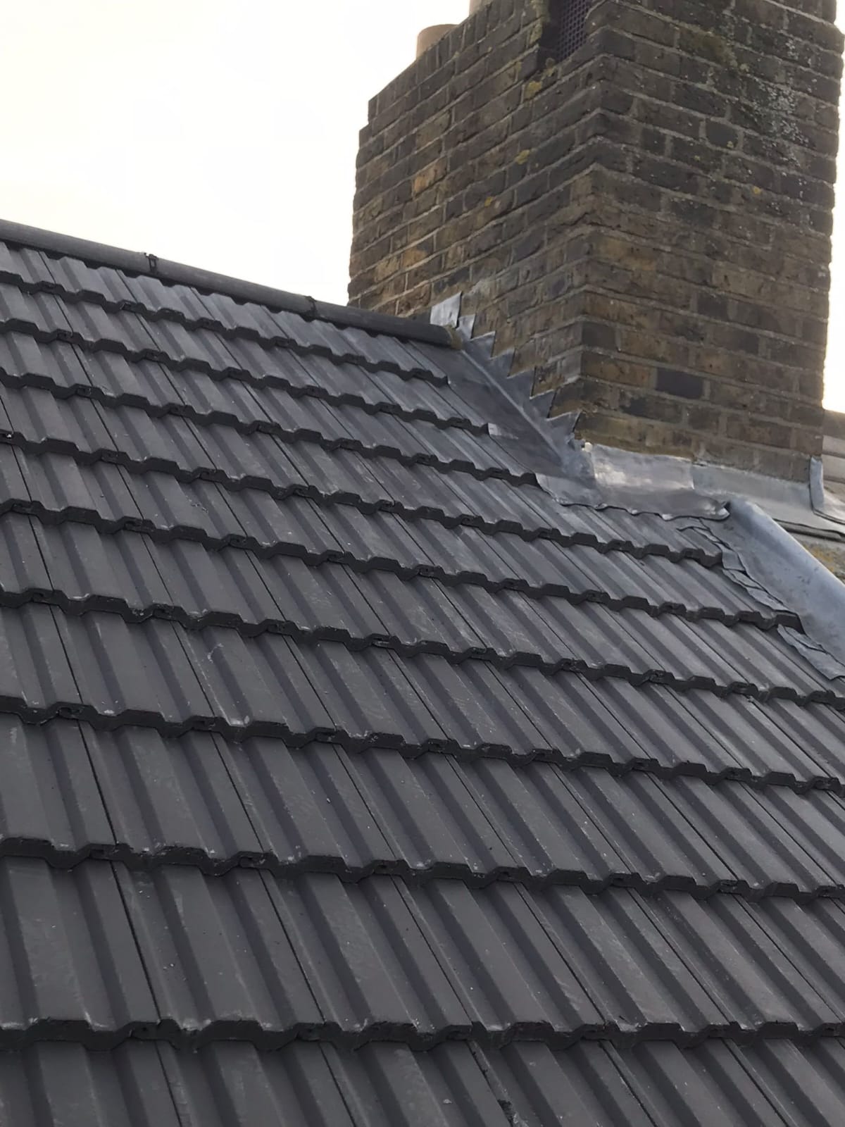 Slate roof with chimney lead flashing